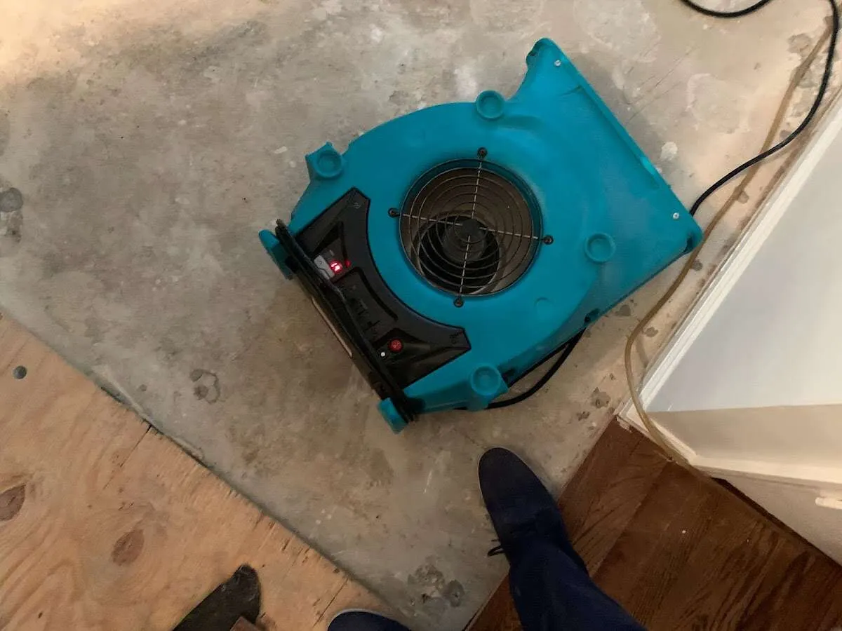 Air mover drying subfloor during Commercial Water Damage Restoration in Brockport